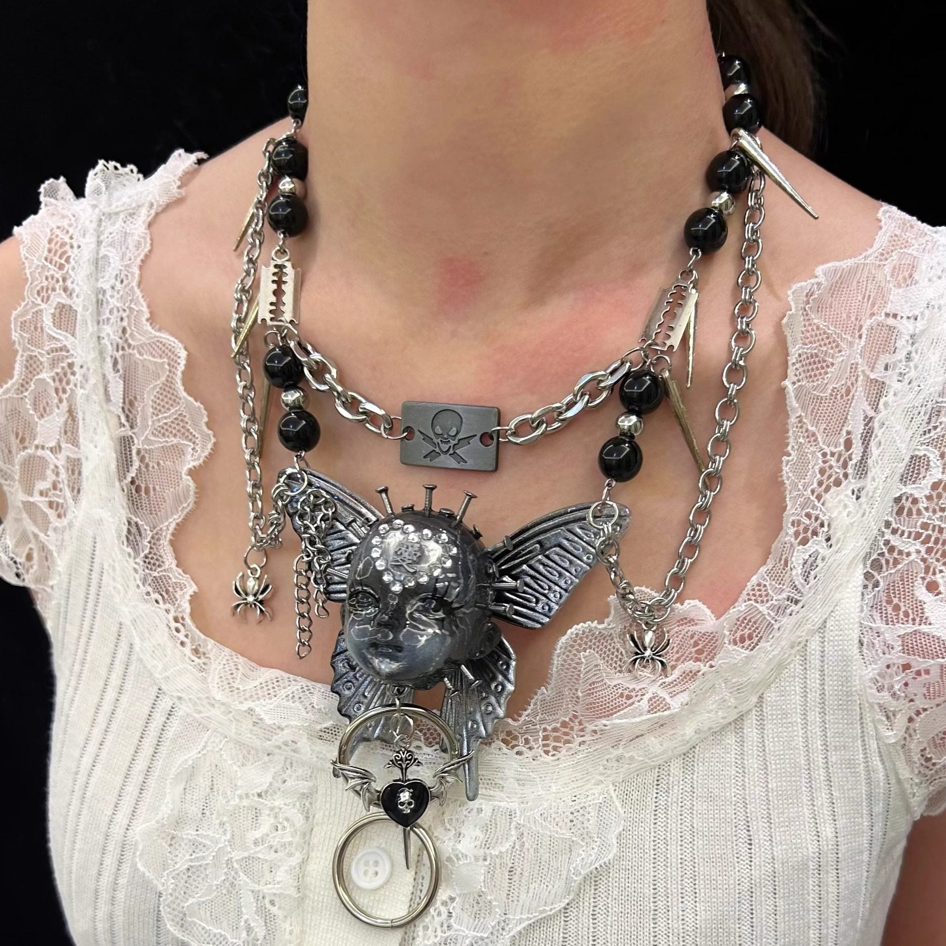 Silver Metallic Butterfly Doll Face Necklace with Rhinestone Heart & Winged Skull Charm