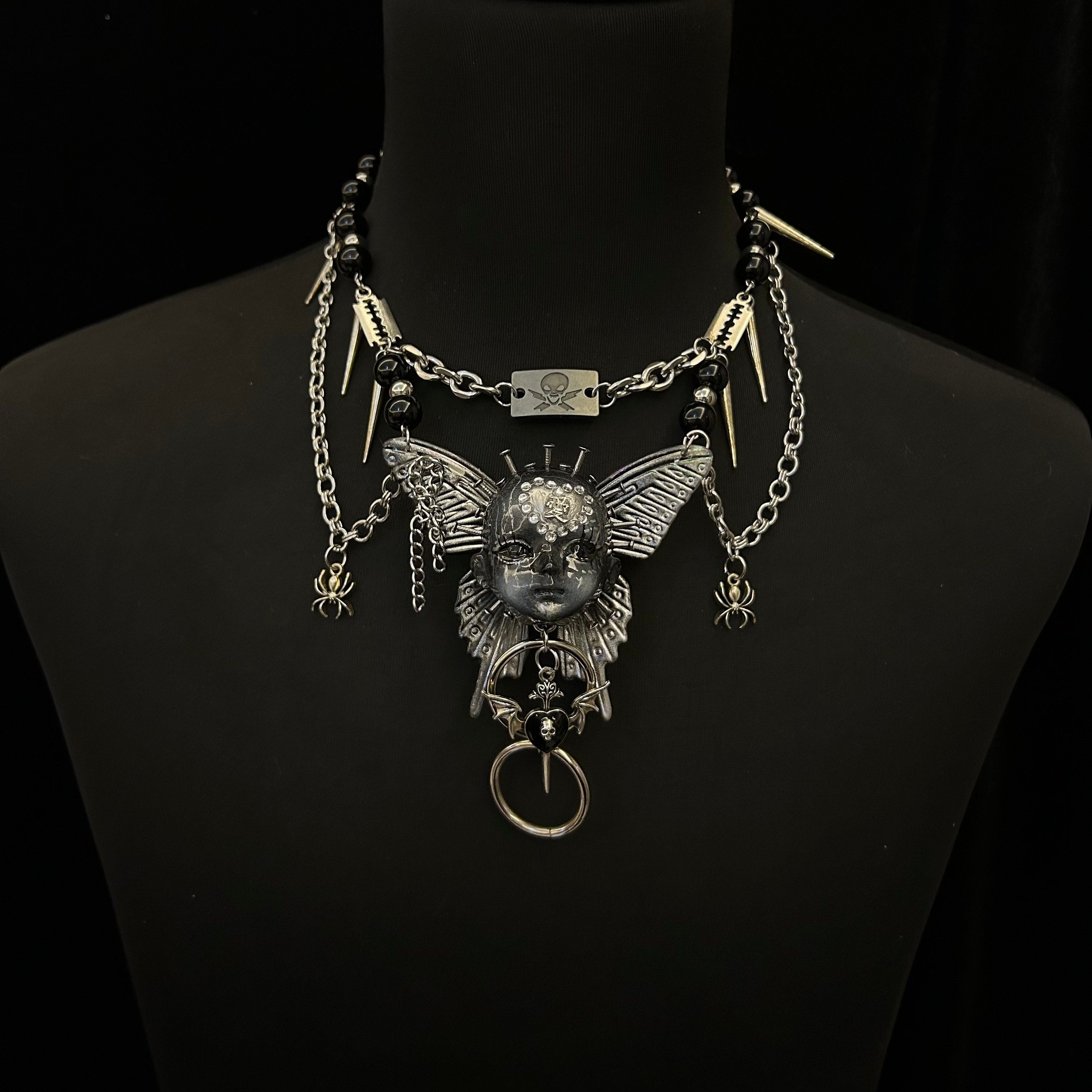 Silver Metallic Butterfly Doll Face Necklace with Rhinestone Heart & Winged Skull Charm