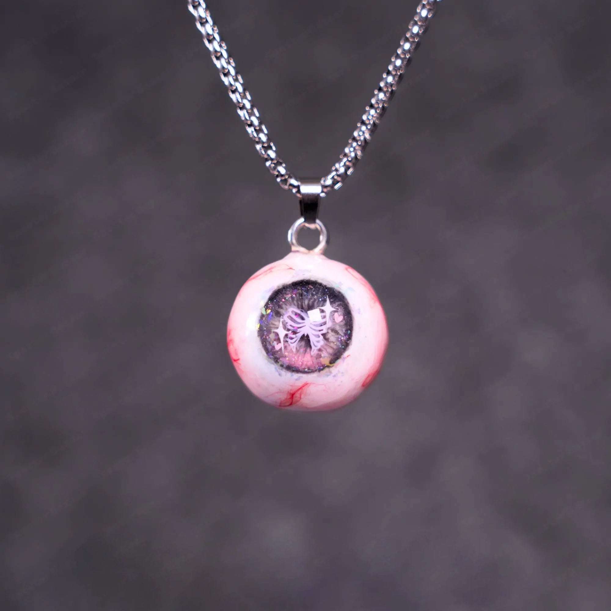 "Pretty Creepy" Coquette Bow Eyeball Necklace - Pink Glitter Ribbon Pupil