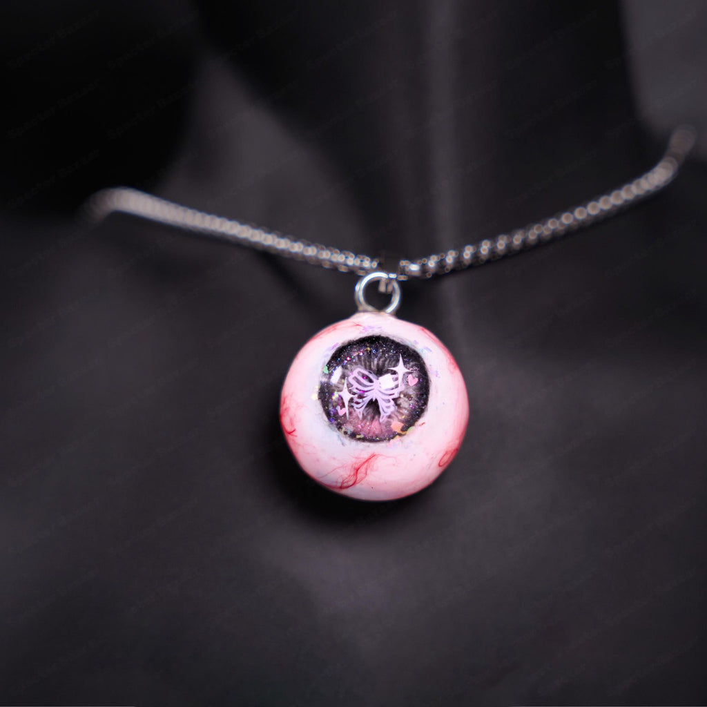 "Pretty Creepy" Coquette Bow Eyeball Necklace - Pink Glitter Ribbon Pupil